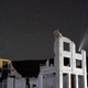 The Comet NEOWISE (C/2020 F3) is seen above the ruins of the Cook Bank building along with diagonal streaks caused by passing satellites in this 20-second camera exposure on July 20, 2020 in the ghost town of Rhyolite, Nevada. The comet is named after NASA’s Near-Earth Object Wide-field Infrared Survey Explorer, which discovered it in March. It is about three miles wide and 70 million miles from Earth while traveling at 144,000 mph as it moves away from the sun.